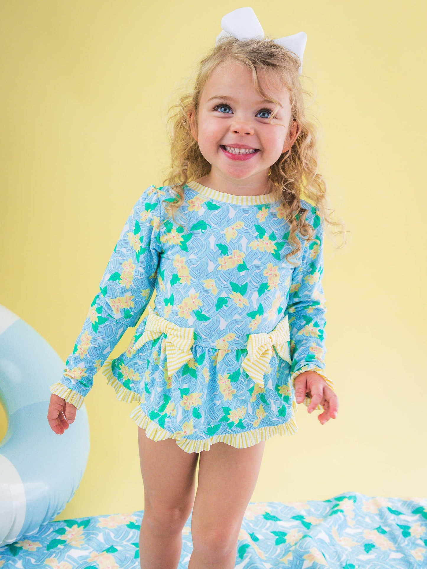 RuffleButts + RuggedButts -  Blooming Basket LS OP Bow Peplum RG Swimsuit