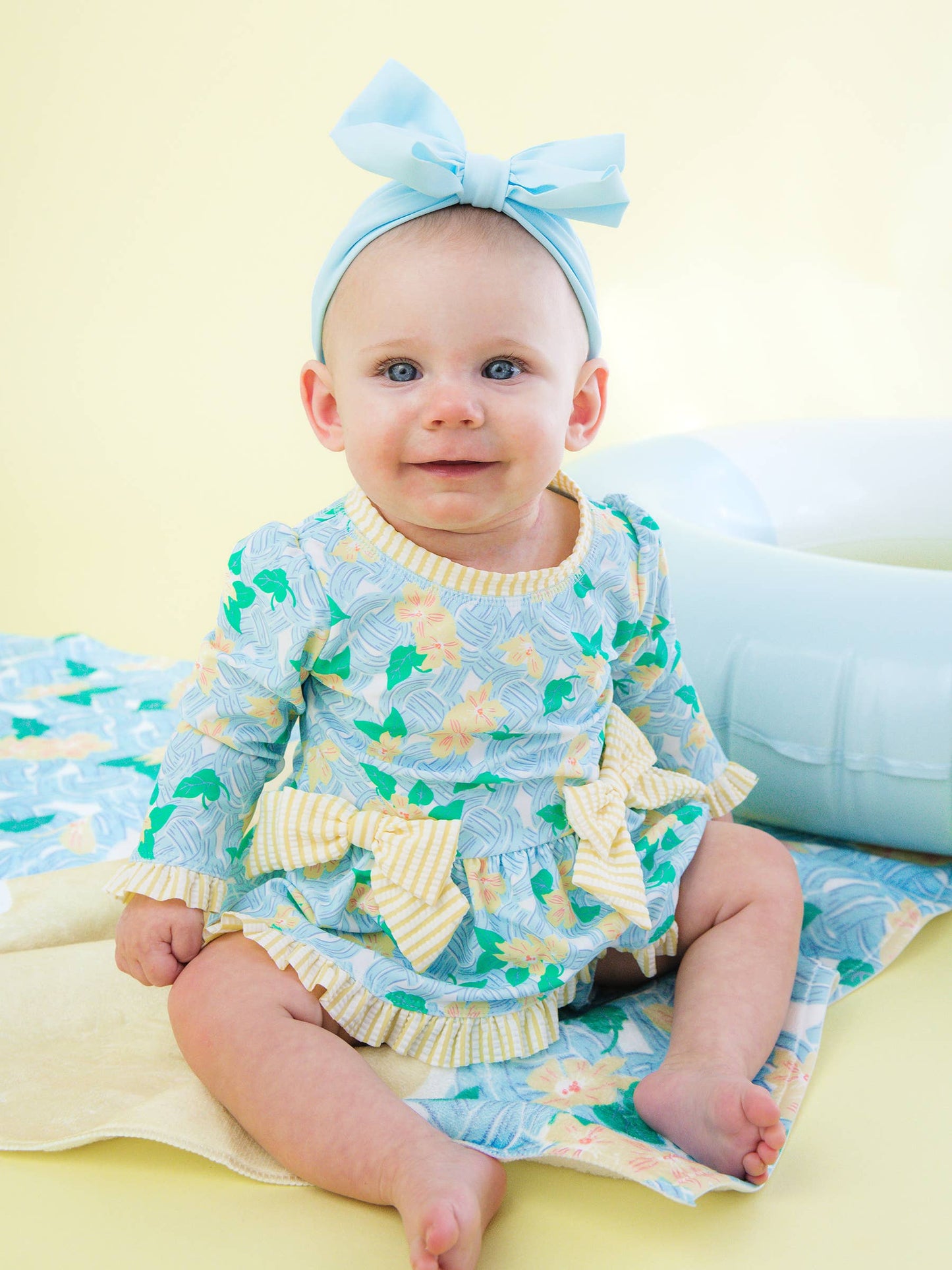RuffleButts + RuggedButts - Baby Girls Blooming Basket LS OP Bow Peplum RG Swimsuit wi/Ruffles