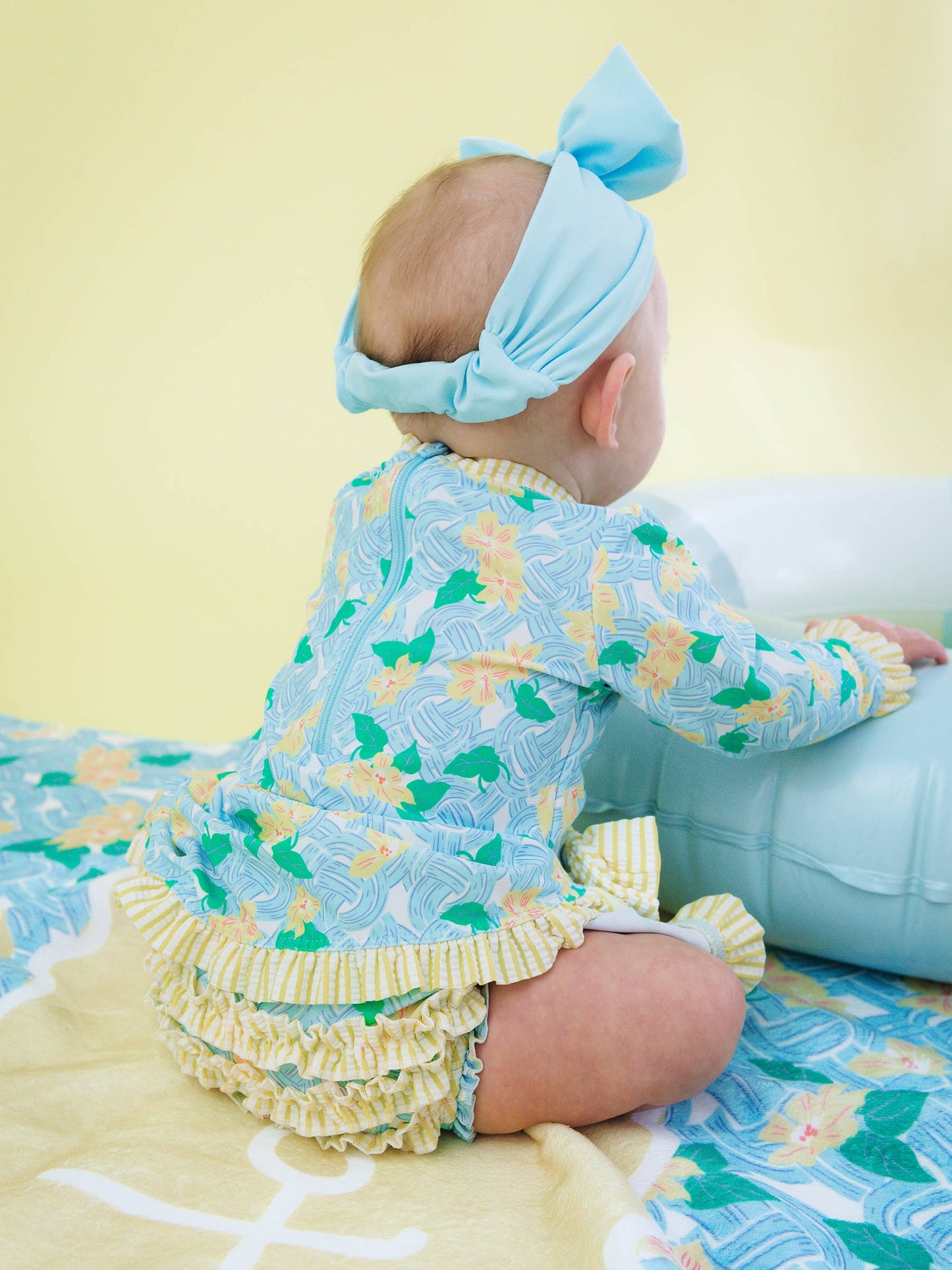RuffleButts + RuggedButts - Baby Girls Blooming Basket LS OP Bow Peplum RG Swimsuit wi/Ruffles
